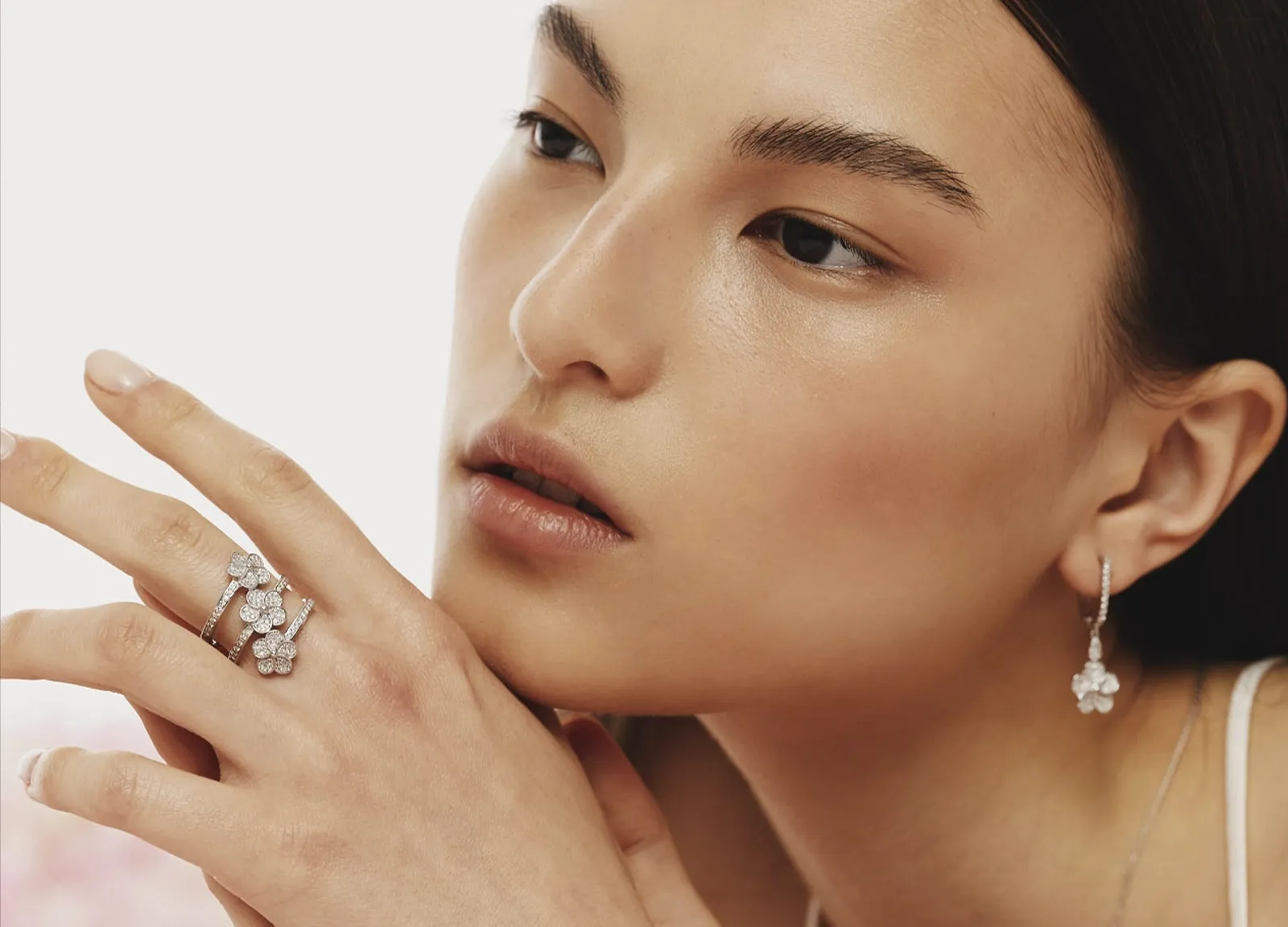 The girl is wearing Sols bespoke spiral ring adorned with flowers and diamonds